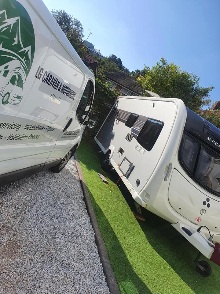 Image of LG Caravan and Motorhome Servicing vehicle next to modern caravan